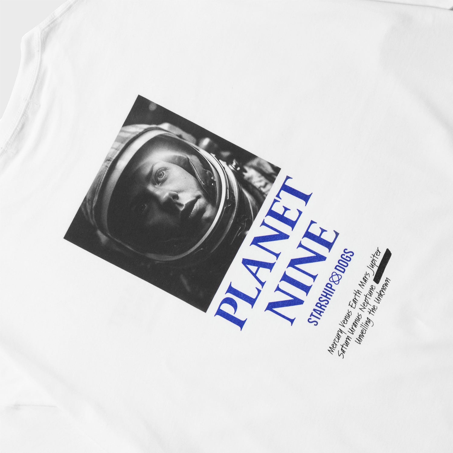 Product Photo: Back print on a white T-shirt. The print showcases a monochrome square photo of a female astronaut's face. Below the photo, the first line reads 'PLANET NINE' in a two-tiered text arrangement. Below that is the brand name 'STARSHIP DOGS.' Further down, in a handwritten-style font, are the names 'Mercury, Venus, Earth, Mars, Jupiter, Saturn, Uranus, Neptune,' followed by another planet name that was previously obscured and blacked out, accompanied by the phrase 'Unveiling the unknown'.