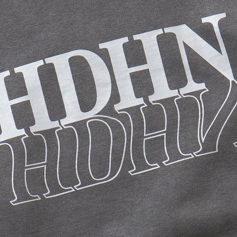 Further Zoomed-In on the Print Section of the Product: A cool sweatshirt in black, with a dark grey feel. The fabric texture is slightly rough, weighing 9.5 oz, and is made of a sturdy, slightly stiff material.