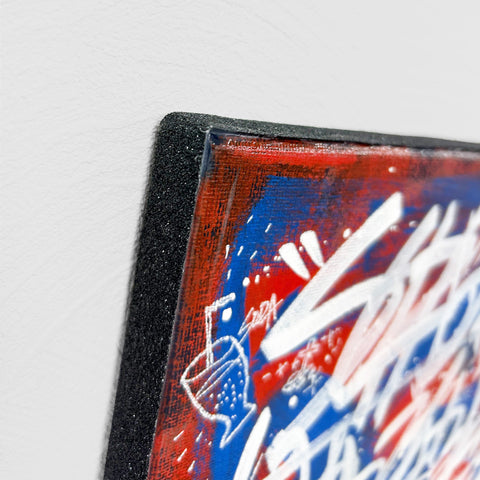 A zoomed-in photo focusing on the left corner of the painting, showing the texture of the skateboard deck tape in detail.